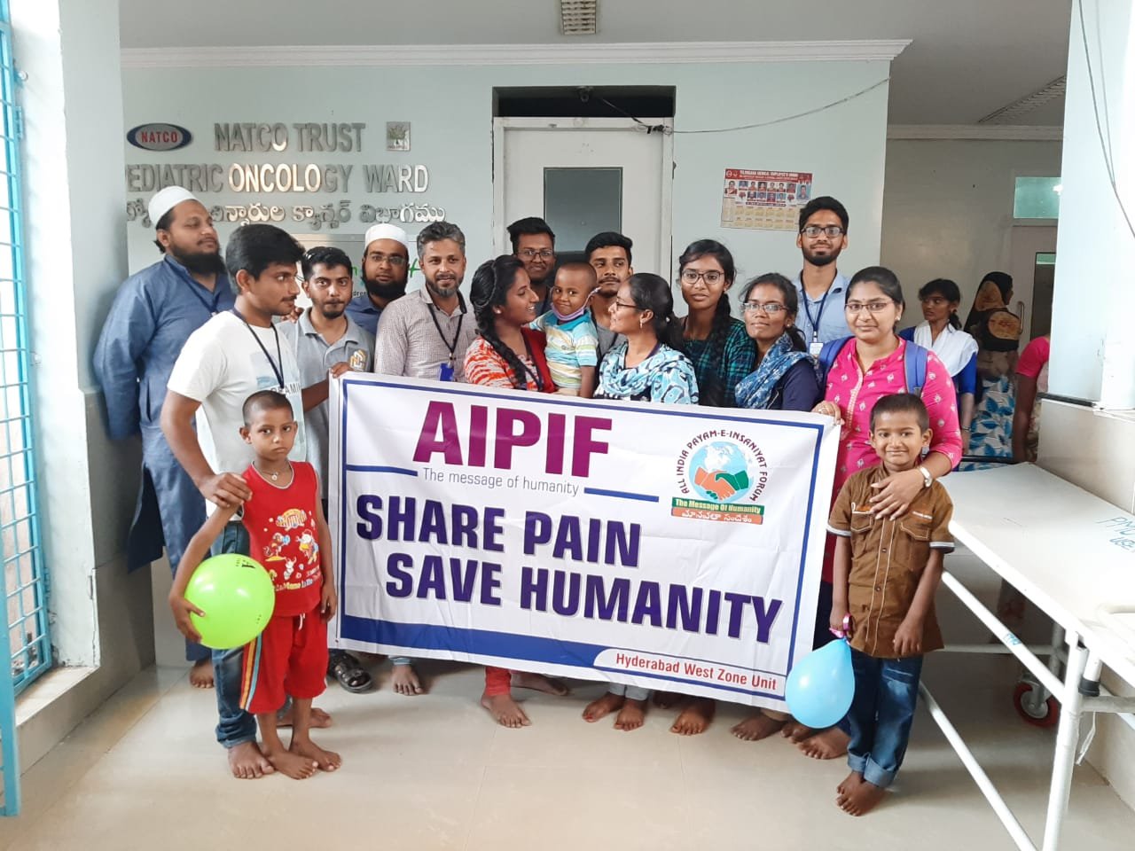 Children receiving fruits distributed by AIPIF volunteers at a hospital